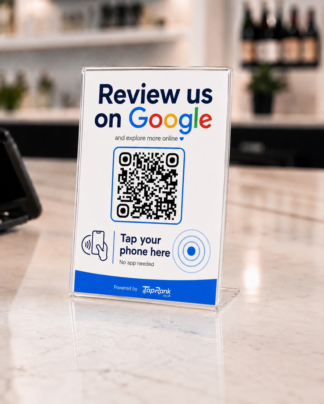 Close-up of a TapRank QR and NFC stand on a reception counter